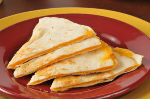 easy cheese quesadilla recipe. cheese quesadilla on a red plate.
